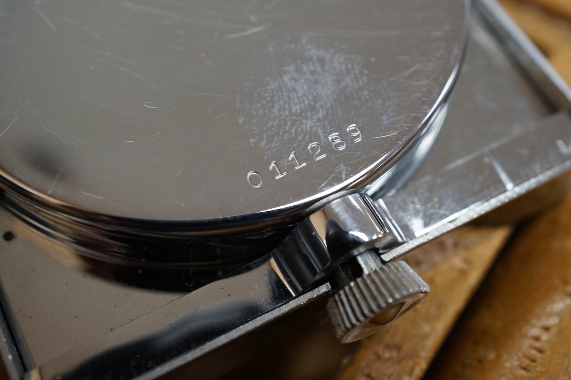 A leather cased chrome LeCoultre 8-day travelling timepiece, 9.5cm wide